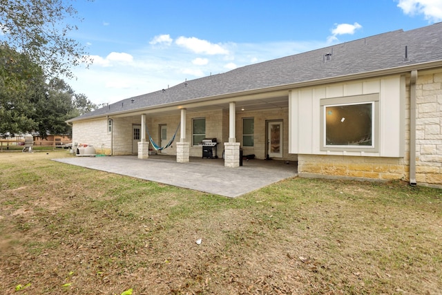 19503 Fisher Dr, Tomball, TX 77377 - rear view of property with a yard, board and batten siding, a patio, and roof with shingles