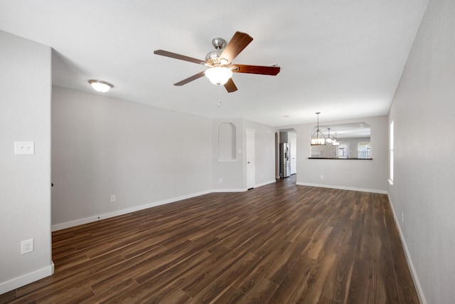 15319 Sableton Crest Ln, Cypress, TX 77429 - unfurnished living room with baseboards, dark wood-style floors, and ceiling fan with notable chandelier