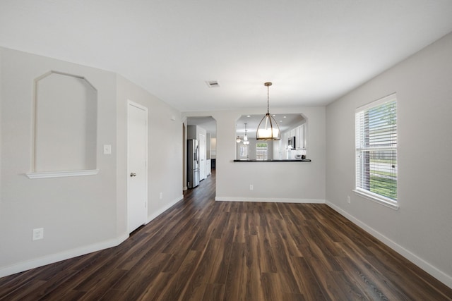 15319 Sableton Crest Ln, Cypress, TX 77429 - unfurnished dining area with baseboards, dark wood-style flooring, a chandelier, and visible vents