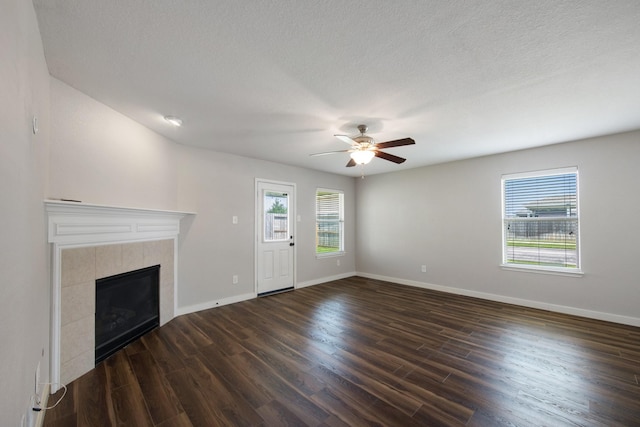 15319 Sableton Crest Ln, Cypress, TX 77429 - unfurnished living room featuring baseboards, dark wood-style flooring, a ceiling fan, and a fireplace