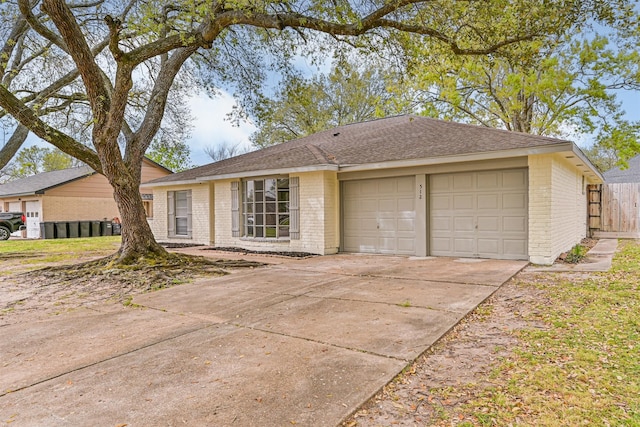 512 Stoneledge Dr, Friendswood, TX 77546 - ranch-style house with brick siding, a garage, concrete driveway, and roof with shingles