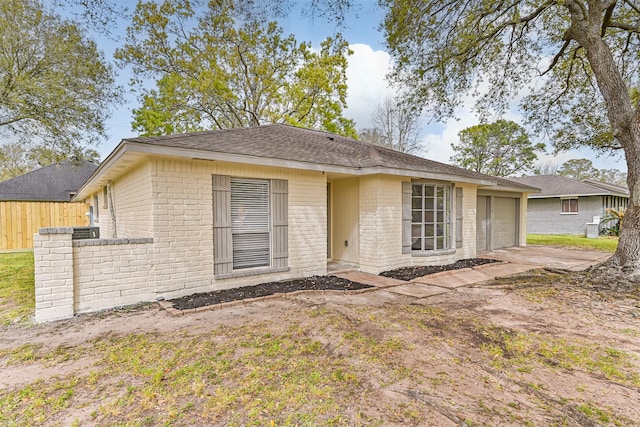 512 Stoneledge Dr, Friendswood, TX 77546 - view of front of property featuring brick siding, a garage, and a shingled roof