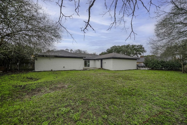 213 Westview Dr, Sealy, TX 77474 - rear view of property with fence and a lawn
