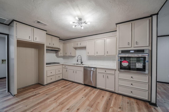 213 Westview Dr, Sealy, TX 77474 - kitchen featuring a sink, stainless steel appliances, visible vents, an inviting chandelier, and light countertops