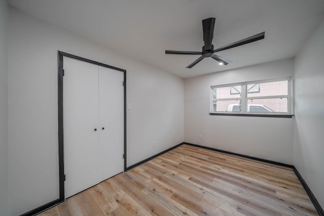 213 Westview Dr, Sealy, TX 77474 - unfurnished bedroom with light wood finished floors, a closet, a ceiling fan, and baseboards