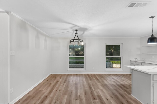 213 Westview Dr, Sealy, TX 77474 - unfurnished dining area featuring light wood-style floors, ornamental molding, and a chandelier