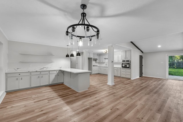 213 Westview Dr, Sealy, TX 77474 - kitchen with a peninsula, oven, light wood-style floors, a chandelier, and open shelves