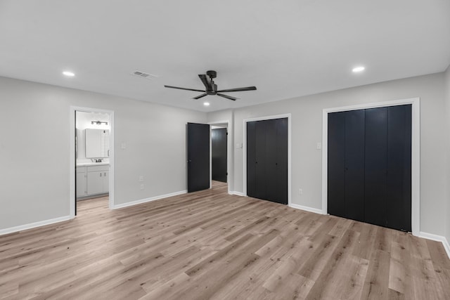 213 Westview Dr, Sealy, TX 77474 - unfurnished bedroom featuring recessed lighting, light wood-style floors, two closets, ensuite bathroom, and ceiling fan