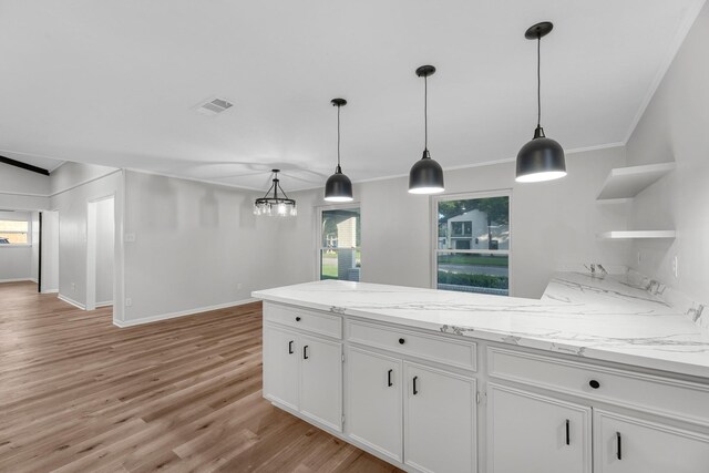 213 Westview Dr, Sealy, TX 77474 - kitchen featuring open shelves, white cabinets, a peninsula, light wood-style floors, and crown molding