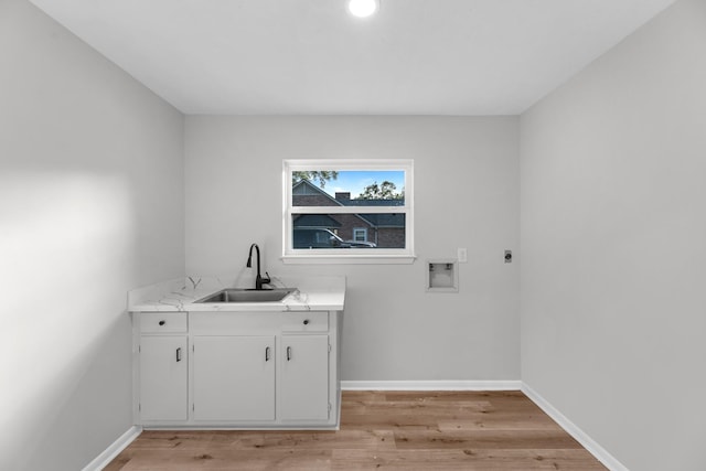 213 Westview Dr, Sealy, TX 77474 - washroom featuring cabinet space, washer hookup, and light wood-type flooring