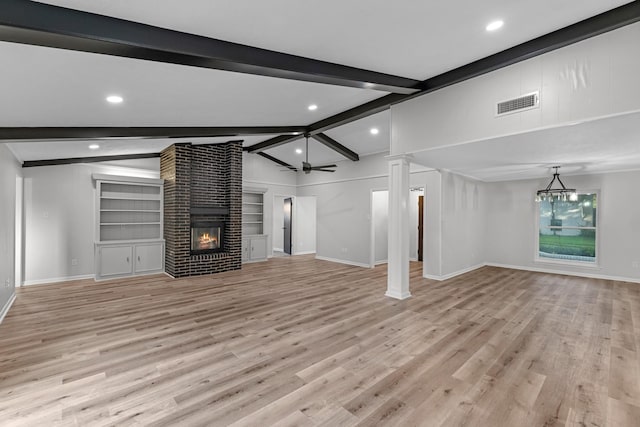 213 Westview Dr, Sealy, TX 77474 - unfurnished living room featuring a brick fireplace, recessed lighting, light wood-style floors, and decorative columns