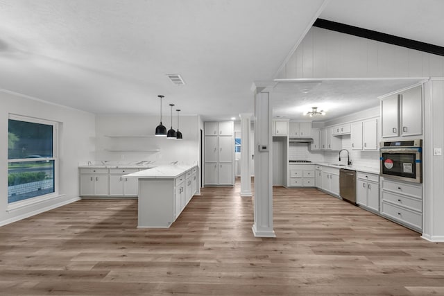 213 Westview Dr, Sealy, TX 77474 - kitchen featuring appliances with stainless steel finishes, light wood finished floors, tasteful backsplash, and light countertops