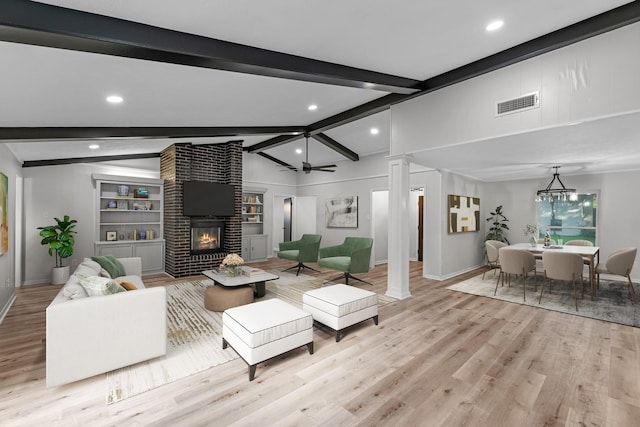 213 Westview Dr, Sealy, TX 77474 - living room with a brick fireplace, light wood-type flooring, recessed lighting, decorative columns, and ceiling fan