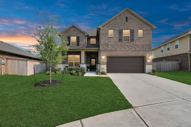 view of front of home with fence, an attached garage, brick siding, driveway, and a front yard
