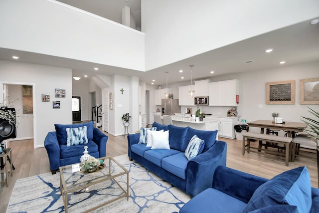 living room with recessed lighting and light wood-type flooring