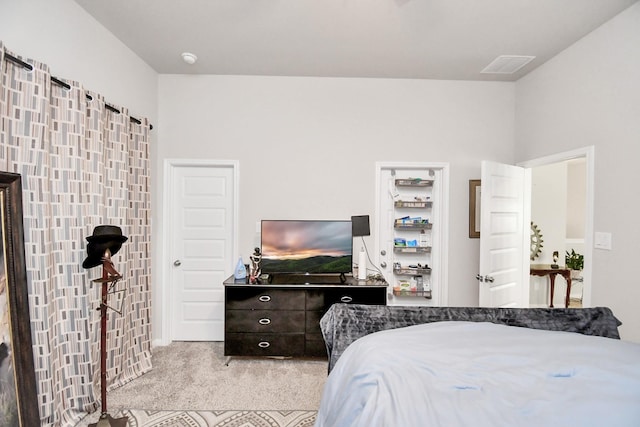 bedroom with light colored carpet and visible vents