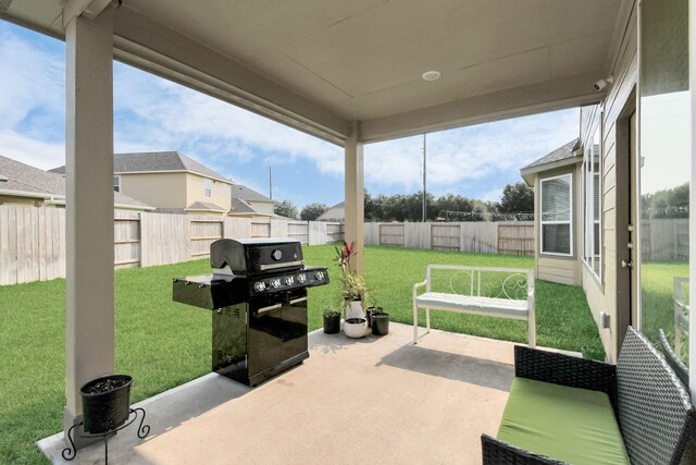 view of patio / terrace with a residential view, a fenced backyard, and grilling area