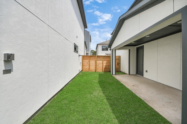 view of yard with a patio and fence
