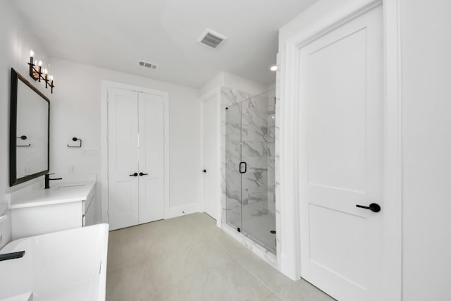 bathroom featuring visible vents, a marble finish shower, and vanity
