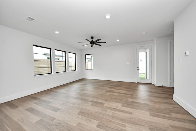 unfurnished room with ceiling fan, light wood-style flooring, visible vents, and recessed lighting
