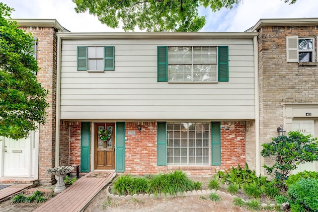 townhome / multi-family property featuring brick siding