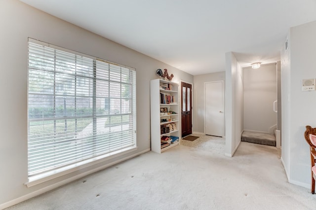 interior space with carpet flooring and baseboards