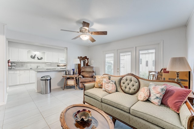 living area featuring light tile patterned floors and a ceiling fan