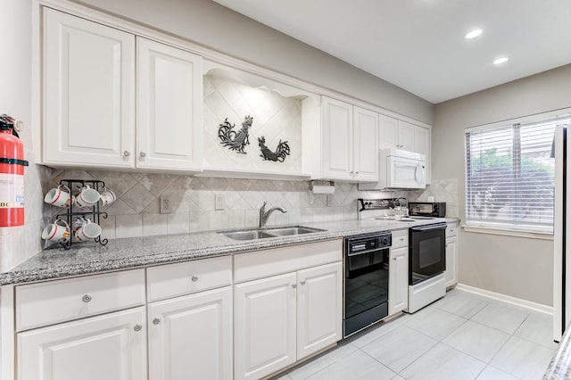 kitchen with a sink, black dishwasher, white microwave, tasteful backsplash, and range with electric stovetop