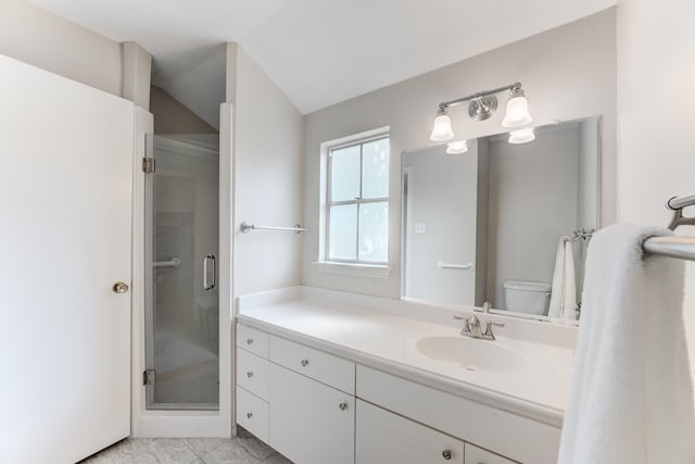 full bath featuring a stall shower, vanity, toilet, and vaulted ceiling