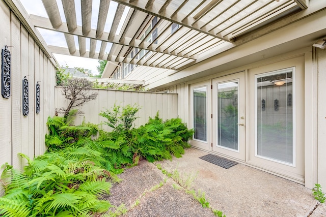 exterior space featuring a pergola, french doors, and fence