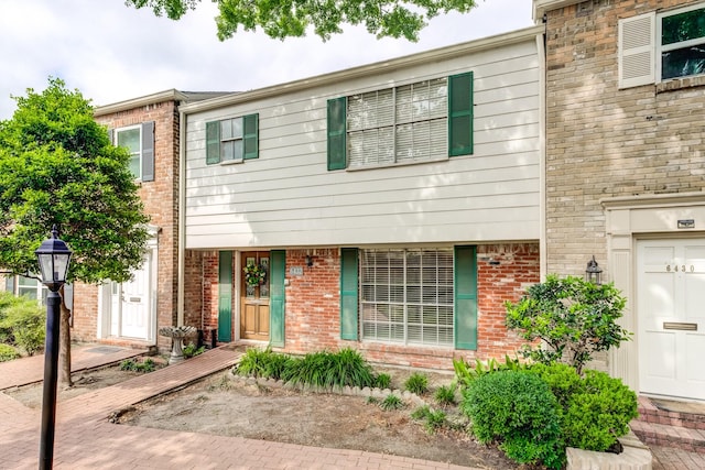 townhome / multi-family property with brick siding