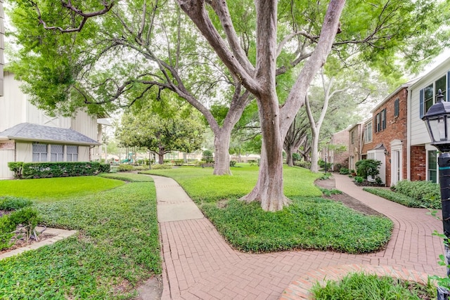 surrounding community with a residential view and a lawn