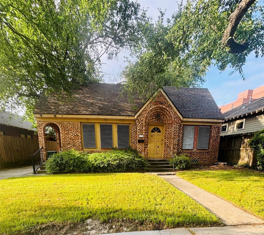 1136 W Cottage St, Houston, TX 77009 - tudor house featuring brick siding and roof with shingles
