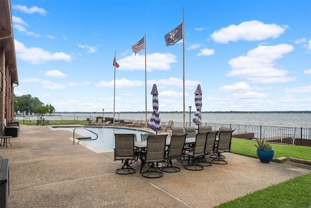 801 River Rd Unit F120, Montgomery, TX 77356 - view of patio / terrace with fence, a water view, and a community pool