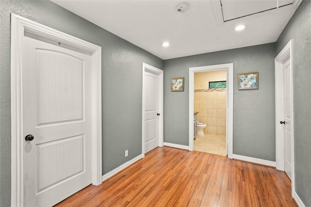 1316 Norham St, Houston, TX 77022 - unfurnished bedroom featuring baseboards, recessed lighting, connected bathroom, and light wood-type flooring