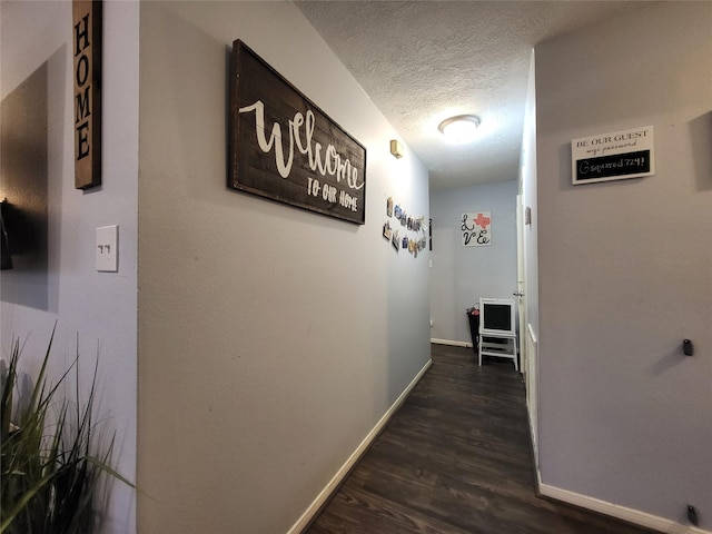 9406 Walnut Glen Dr, Houston, TX 77064 - hallway with baseboards, a textured ceiling, and dark wood finished floors