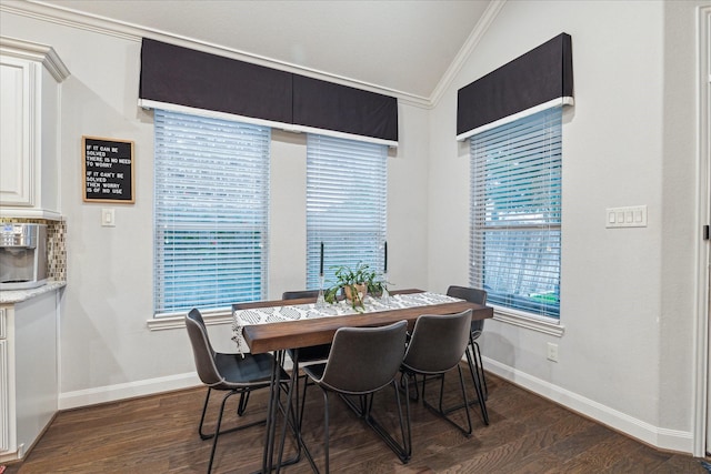 dining room featuring baseboards, dark wood finished floors, crown molding, and vaulted ceiling