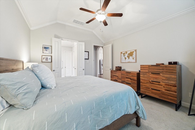 bedroom with ceiling fan, visible vents, crown molding, vaulted ceiling, and light colored carpet
