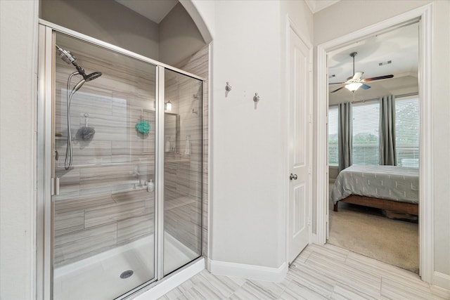 bathroom with connected bathroom, baseboards, a stall shower, and ceiling fan