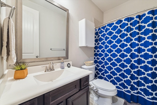 bathroom featuring vanity, toilet, and a shower with shower curtain