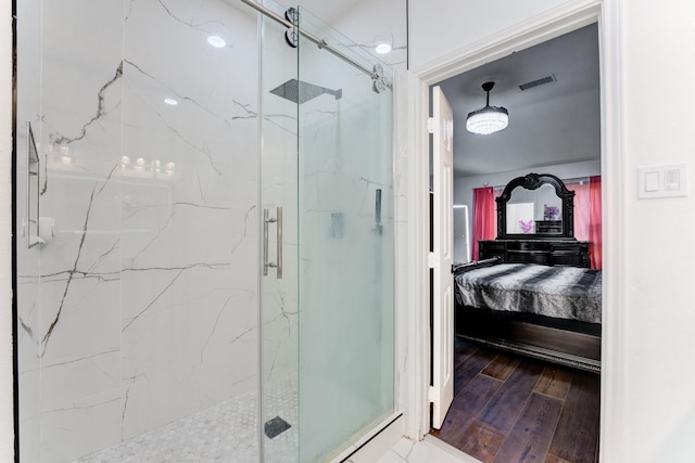 bathroom featuring ensuite bath, visible vents, a marble finish shower, and wood finished floors