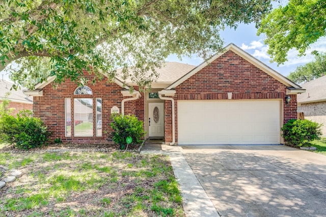 view of front of property featuring concrete driveway, brick siding, and a garage