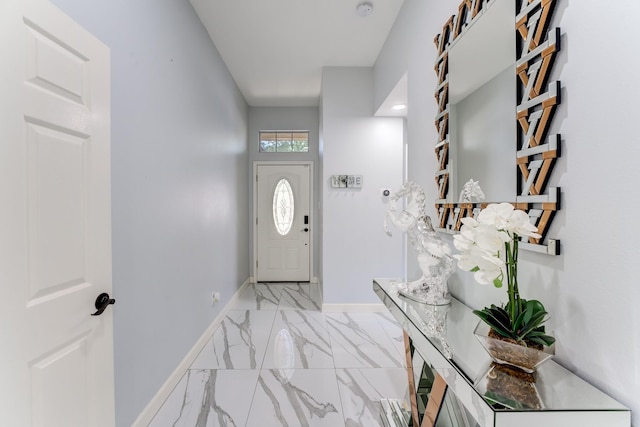 entryway featuring marble finish floor and baseboards