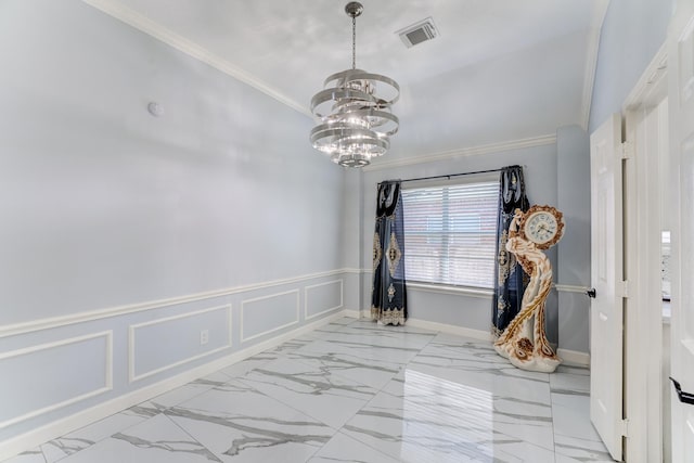 spare room featuring marble finish floor, a notable chandelier, visible vents, and crown molding