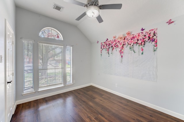 spare room with baseboards, wood finished floors, ceiling fan, and vaulted ceiling