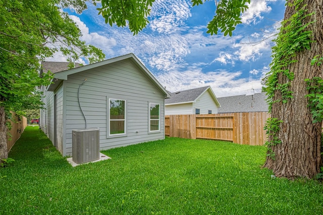 7307 W Knoll St, Houston, TX 77028 - back of property featuring fence, cooling unit, and a lawn