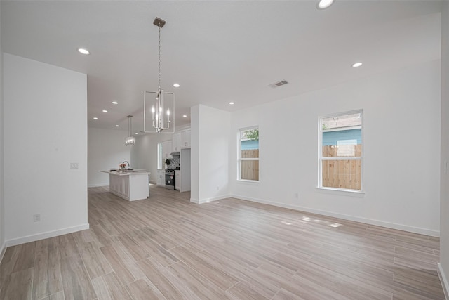 7307 W Knoll St, Houston, TX 77028 - unfurnished living room featuring baseboards, recessed lighting, light wood-style flooring, and visible vents