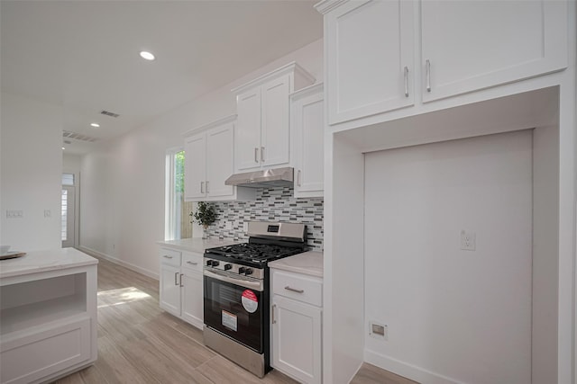 7307 W Knoll St, Houston, TX 77028 - kitchen featuring visible vents, recessed lighting, under cabinet range hood, white cabinetry, and gas range