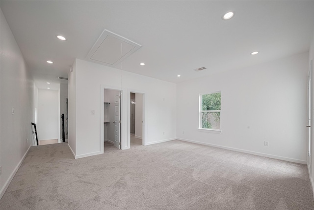 7307 W Knoll St, Houston, TX 77028 - unfurnished bedroom with recessed lighting, attic access, visible vents, a walk in closet, and light colored carpet