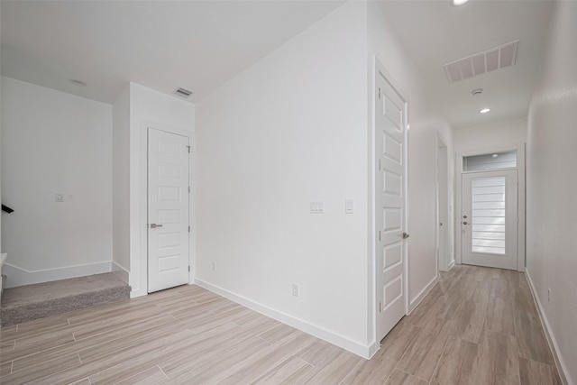 7307 W Knoll St, Houston, TX 77028 - corridor featuring visible vents, light wood-style flooring, baseboards, and stairway